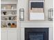 Close-up of the fireplace showcasing the mantel, built-in shelves, and decorative items at 2749 Porches Ln, Dacula, GA 30019