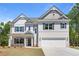 Beautiful two-story home boasts a brick and siding exterior, attached two-car garage, and well-manicured front yard at 2749 Porches Ln, Dacula, GA 30019