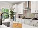 Bright kitchen with white cabinets, neutral backsplash, stainless appliances and eat-in island at 2749 Porches Ln, Dacula, GA 30019