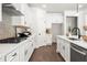 A modern kitchen with white cabinets, stainless steel appliances, and hardwood floors at 2749 Porches Ln, Dacula, GA 30019