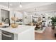 Open-concept kitchen with stainless steel appliances flowing into the dining and living areas at 2749 Porches Ln, Dacula, GA 30019