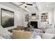 Well-decorated living room featuring coffered ceilings, built-in shelves, fireplace and stylish furniture at 2749 Porches Ln, Dacula, GA 30019