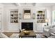 A living room features built in cabinets, a fire place and a wood-look coffee table at 2749 Porches Ln, Dacula, GA 30019