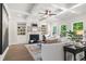 Elegant living room featuring coffered ceilings, a fireplace, built-in shelves, and large windows at 2749 Porches Ln, Dacula, GA 30019