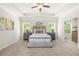 Stylish main bedroom featuring tray ceilings, elegant furnishings, and bright windows at 2749 Porches Ln, Dacula, GA 30019