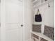 Mudroom with a built-in bench, storage shelves, hooks and a neutral color scheme at 2749 Porches Ln, Dacula, GA 30019