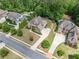 Wide aerial view of a luxury home with trees and landscaping surrounding the property at 390 Scott Farm Dr, Powder Springs, GA 30127