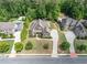 Aerial view showcasing a luxurious home with lush landscaping, a private pool, and a spacious driveway at 390 Scott Farm Dr, Powder Springs, GA 30127