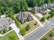 Overhead view showcases home's manicured lawn, trees, and large driveway at 390 Scott Farm Dr, Powder Springs, GA 30127