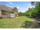 Backyard with large green lawn, covered seating area and view of siding and windows at 390 Scott Farm Dr, Powder Springs, GA 30127