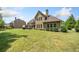 Large backyard features a patio, green lawn, and partial view of the home at 390 Scott Farm Dr, Powder Springs, GA 30127