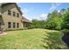 Spacious backyard with healthy green lawn and landscaping with a view of the home's exterior at 390 Scott Farm Dr, Powder Springs, GA 30127