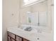 Bathroom featuring a dual vanity, chrome fixtures, and a large mirror at 390 Scott Farm Dr, Powder Springs, GA 30127