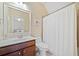 This bathroom features a single sink vanity, and tiled shower, designed for functionality and style at 390 Scott Farm Dr, Powder Springs, GA 30127
