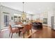 Bright dining area adjacent to the kitchen with outdoor access and views to an island with barstool seating at 390 Scott Farm Dr, Powder Springs, GA 30127