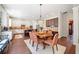 Dining area offering a view to the kitchen, with white cabinets and a dark wood island with bar stools at 390 Scott Farm Dr, Powder Springs, GA 30127