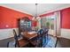 Formal dining room with elegant chandelier, decorative china cabinet, and large window at 390 Scott Farm Dr, Powder Springs, GA 30127