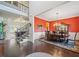 Elegant dining room with red accent wall, hardwood floors, and statement chandelier fixture at 390 Scott Farm Dr, Powder Springs, GA 30127
