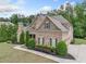 Elegant brick home with a well-maintained lawn, mature landscaping, and a spacious driveway at 390 Scott Farm Dr, Powder Springs, GA 30127