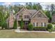 Charming brick home with stone accents, manicured landscaping, and a welcoming entrance at 390 Scott Farm Dr, Powder Springs, GA 30127
