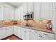 Gourmet kitchen features stainless appliances, gas cooktop, and ample counter space at 390 Scott Farm Dr, Powder Springs, GA 30127