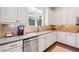 Bright kitchen features granite countertops, stainless steel appliances, and custom backsplash at 390 Scott Farm Dr, Powder Springs, GA 30127