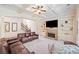 Inviting living room with stone fireplace, built-in bookshelves, and coffered ceiling at 390 Scott Farm Dr, Powder Springs, GA 30127