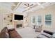 Cozy living room featuring built-in bookcases, a stone fireplace, and a coffered ceiling at 390 Scott Farm Dr, Powder Springs, GA 30127