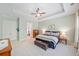 Bright main bedroom has neutral paint and carpet and an ensuite bathroom at 390 Scott Farm Dr, Powder Springs, GA 30127