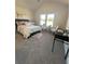 Sunlit bedroom with large windows, a seating area, and stylish decor at 4010 Sierra Knolls Ct, Cumming, GA 30040
