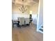 Dining room with chandelier, hardwood floors, and wainscoting at 4010 Sierra Knolls Ct, Cumming, GA 30040