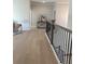Hallway featuring hardwood floors and a staircase with black railings at 4010 Sierra Knolls Ct, Cumming, GA 30040