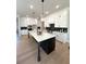 Bright kitchen with white cabinets, large center island, and modern appliances at 4010 Sierra Knolls Ct, Cumming, GA 30040