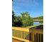 Scenic lake view with trees and beautiful sky from a wooden deck with rail at 4010 Sierra Knolls Ct, Cumming, GA 30040