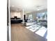 Open-concept living room with hardwood floors, comfortable seating, and view into the kitchen at 4010 Sierra Knolls Ct, Cumming, GA 30040