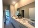 Bathroom suite boasts a double sink vanity and bright lighting at 4050 Sierra Vista Cir, Cumming, GA 30040