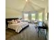 Carpeted bedroom with a high ceiling, windows, and decor at 4050 Sierra Vista Cir, Cumming, GA 30040
