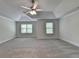 Spacious bedroom featuring tray ceilings, carpet flooring, and abundant natural light at 4050 Sierra Vista Cir, Cumming, GA 30040
