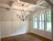 Elegant dining room with coffered ceiling, wainscoting, and large windows at 4050 Sierra Vista Cir, Cumming, GA 30040