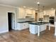 Modern kitchen with white cabinets, stainless steel appliances, and center island at 4050 Sierra Vista Cir, Cumming, GA 30040