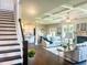 Inviting living space showcases an open layout, fireplace, modern decor, and staircase at 4050 Sierra Vista Cir, Cumming, GA 30040