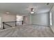Spacious carpeted loft with ceiling fan and black iron railing at 4050 Sierra Vista Cir, Cumming, GA 30040
