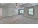 Spacious bedroom featuring tray ceilings, carpet flooring, and abundant natural light at 4050 Sierra Vista Cir, Cumming, GA 30040