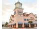 Exterior view of North Georgia Premium Outlets with pink facade and retail storefronts at 4050 Sierra Vista Cir, Cumming, GA 30040