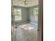 Bedroom with new flooring, gray paint, and ceiling fan at 201 Deerfield Ln, Carrollton, GA 30116