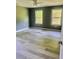 Spacious bedroom with light hardwood flooring and two windows at 201 Deerfield Ln, Carrollton, GA 30116