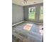 Well lit bedroom with new flooring, paint, and two windows at 201 Deerfield Ln, Carrollton, GA 30116