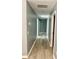 Hallway featuring new hardwood floors and neutral gray paint at 201 Deerfield Ln, Carrollton, GA 30116
