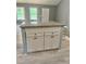 New kitchen island with granite countertop and grey cabinets gives a homey and simple yet modern vibe at 201 Deerfield Ln, Carrollton, GA 30116