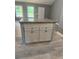 New kitchen island with granite countertop and grey cabinets gives a homey and simple yet modern vibe at 201 Deerfield Ln, Carrollton, GA 30116